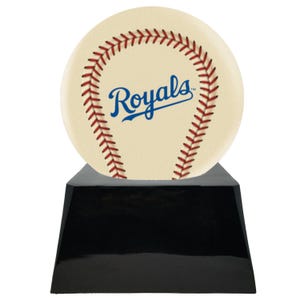 May include: A baseball-themed trophy featuring a cream-colored baseball with red stitching and the word "Royals" in blue script. The baseball sits atop a glossy black, trapezoid-shaped base. A sports-themed award.
