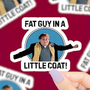 May include: A sticker featuring a cartoon image of a man in a yellow and black coat, with the text "FAT GUY IN A LITTLE COAT!". The sticker is white with a black border and is on a maroon background.