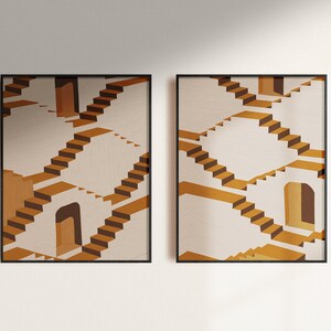 May include: Two framed prints of an abstract geometric design featuring a repeating pattern of stairs and doorways in shades of brown, beige, and white.