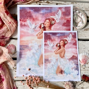 May include: Two watercolor prints of a woman with flowing white fabric and doves flying above her. The woman is holding a seashell to her ear. The background is a sunset over the ocean.