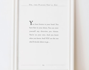 May include: A white framed wall art print featuring the text Oh, the Places You'll Go! and a quote from the book, positioned above a pair of mustard yellow linen overalls with cross-back straps and two front buttons on the waistband.