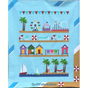 May include: A blue and white quilt with a beach scene. The quilt features a Ferris wheel, a roller coaster, beach umbrellas, beach houses, palm trees, and a sailboat. The quilt is bordered with a brown and white striped fabric and a red and white striped fabric. The text "QuiltFabrication" is printed in the bottom center of the quilt.