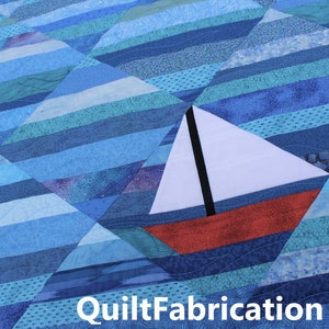 May include: A blue and white quilt with a red and white sailboat in the center. The quilt is made of various shades of blue fabric and has a quilted pattern. The sailboat is a simple design with a white sail and a red hull. The quilt is a great example of a handmade craft.
