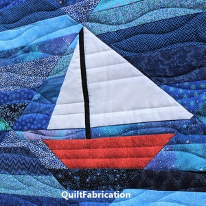 May include: A white sailboat with a black mast and red hull is appliqued on a blue and teal quilt. The quilt is made of various fabrics with different patterns and textures. The quilt is quilted with a wavy pattern. The text "QuiltFabrication" is visible in the bottom right corner of the image.