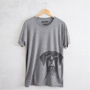 May include: A heather grey t-shirt with a black and white illustration of a German Shorthaired Pointer wearing sunglasses. The shirt has the text "Inktopious" printed on the front.