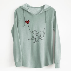 May include: A light green hooded sweatshirt with a black and white illustration of a dog holding a red heart-shaped balloon.
