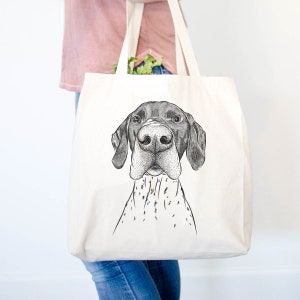 May include: A white canvas tote bag with a black and white illustration of a German Shorthaired Pointer dog. The dog is looking directly at the viewer with its tongue out.