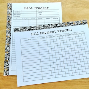 May include: Two printable pages with a zebra print border. The top page is a debt tracker with columns for company, total owed, minimum payment, interest rate, starting balance, payment, principle, interest, and remaining. The bottom page is a bill payment tracker with columns for name, due date, and each month of the year.