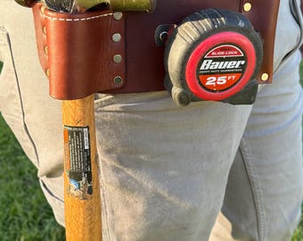 Soporte para martillo y cinta métrica con estuche para lápiz, de cuero resistente.