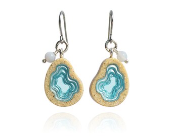 Ocean inspired Basin dangle earrings crafted from sand and aquamarine blue resin with two agate gemstones on stainless steel ear wires