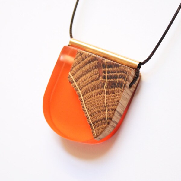 Large pendant handmade from Australian wood and organge / apricot coloured resin on dark brown waxed cord with a brass tube on top.