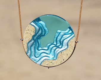 The Abyss - Beach necklace with round pendant handmade from sand and aqua blue resin on cord
