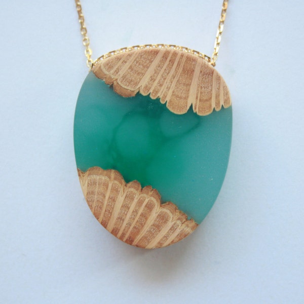 Egg shaped pendant from Australian wood and bright blue and green resin on a 16K gold plated chain