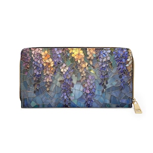 May include: A zippered wallet featuring a mosaic-style floral design with wisteria blooms in shades of purple, yellow, and blue. The wallet has a gold-colored zipper and pull, and a black border.