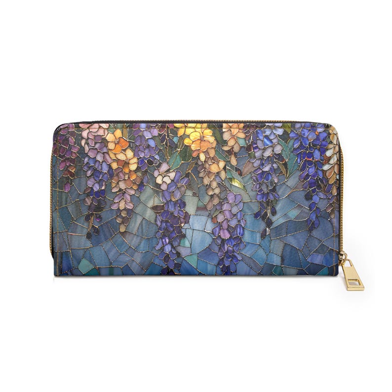 May include: A zippered wallet featuring a mosaic-style floral design with wisteria blooms in shades of purple, yellow, and blue. The wallet has a gold-colored zipper and pull, and a black border.