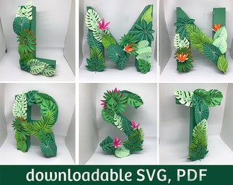 May include: A collection of green paper letters, including L, M, N, R, S, and T, decorated with tropical leaves and flowers. The letters are in a 3D style, with various shades of green and accents of pink and orange. The bottom of the image has the text "downloadable SVG, PDF".