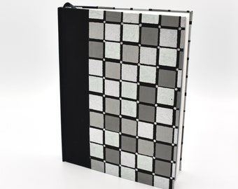 Handmade bullet journal with gray and white squares on cover