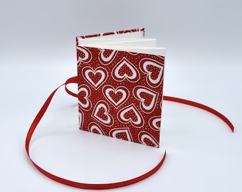 Handmade mini accordion album with white hearts on red