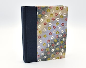 Handmade blank travel journal with small flowers on muted background