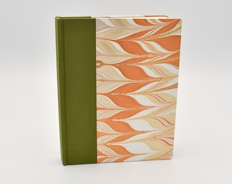 Handmade blank travel journal with orange and cream marbling