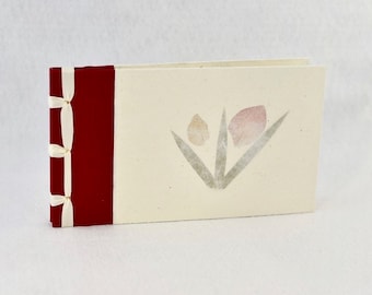 Handmade photo album with inlaid flower design on cream