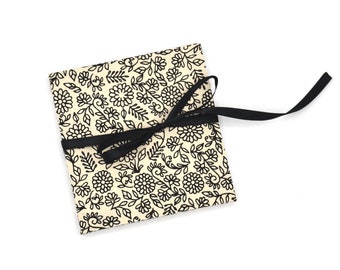 Handmade mini accordion album with small black flowers on white