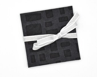 Handmade mini accordion album with raised rectangles on black