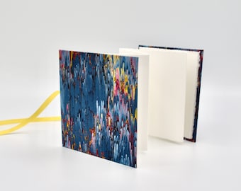 Handmade mini accordion album with blue, pink, and yellow marble cover