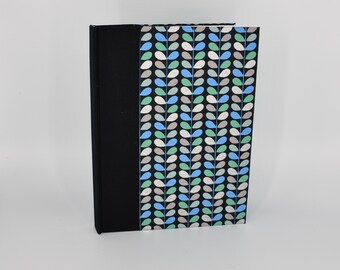 Handmade blank journal with leaf patterns in blue and green on black