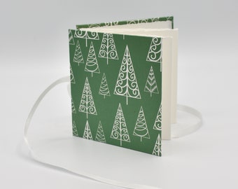 Handmade mini accordion album with white tree outlines on green