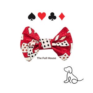 May include: A red bow tie with a playing card pattern, featuring spades, hearts, clubs, and diamonds symbols. The text "The Full House" is printed on the bow tie. A line drawing of a dog is in the lower right corner.