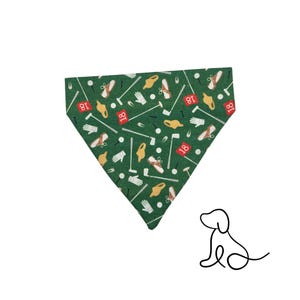 May include: Green dog bandana with a golf-themed pattern. The fabric features golf shoes, golf balls, gloves, golf clubs, and the number 18. The bandana is triangular and designed to be worn around a dog's neck.