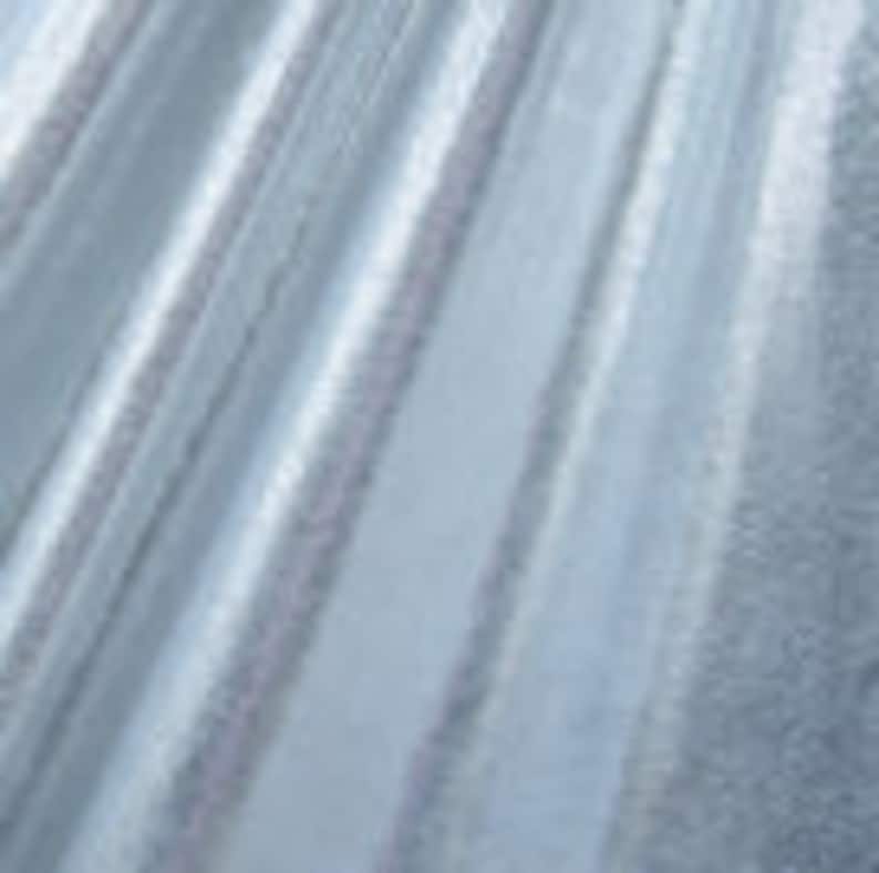 May include: White sheer fabric with a subtle shimmer. The fabric has a delicate texture and a soft, flowing drape.