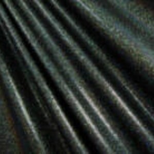 May include: A dark green fabric with a subtle, light gold pattern. The fabric has a smooth, silky texture.
