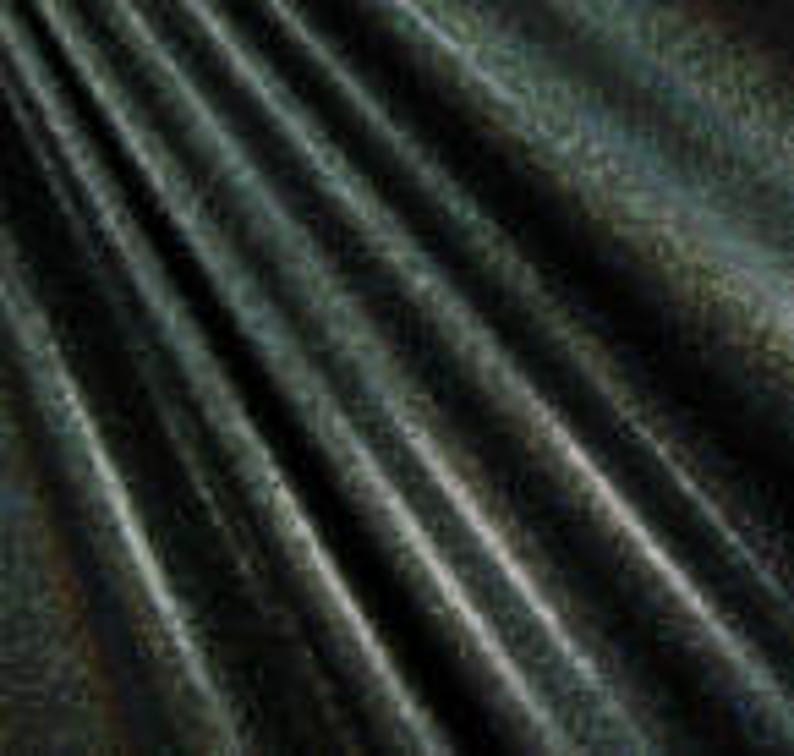 May include: A dark green fabric with a subtle, light gold pattern. The fabric has a smooth, silky texture.