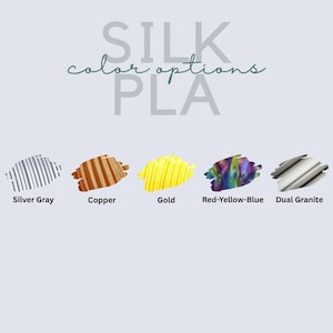 May include: A color chart titled SILK color options PLA displaying five material samples. The options include Silver Gray, Copper, Gold, a multi-colored Red-Yellow-Blue blend, and a Dual Granite finish, each shown as a textured swatch.
