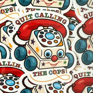 May include: A collection of stickers featuring a retro-style toy telephone with a smiling face, blue wheels, and a red receiver. The text "QUIT CALLING THE COPS!" is prominently displayed.