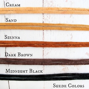 May include: Five suede leather strips in different colors: cream, sand, sienna, dark brown, and midnight black. The text "SUEDE COLORS" is at the bottom of the image.