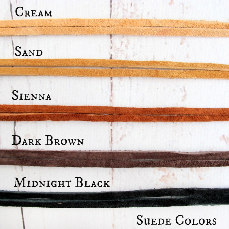 May include: Five suede leather strips in different colors: cream, sand, sienna, dark brown, and midnight black. The text "SUEDE COLORS" is at the bottom of the image.