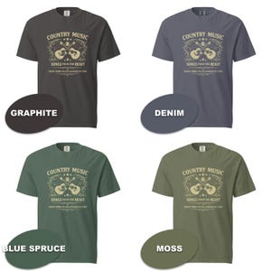 May include: Four short-sleeved t-shirts in graphite, denim, blue spruce, and moss colors. Each shirt features the text "COUNTRY MUSIC" above a guitar graphic and the text "SONGS FROM THE HEART".