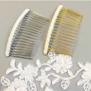 May include: Two hair combs with white tips. One comb is silver and the other is gold.