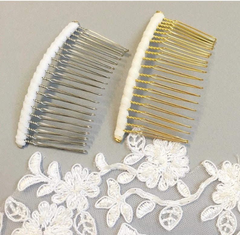 May include: Two hair combs with white tips. One comb is silver and the other is gold.