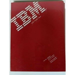 May include: A package of IBM Color Plotter Paper with a red cover. The IBM logo and "Color Plotter Paper" are printed in white. The package contains 50 blank sheets, 8.5 x 11 inches, and is packaged with the smooth side up.