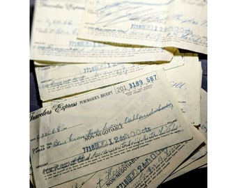 May include: A stack of vintage Travelers Express money orders. The money orders are yellowed with age and have handwritten amounts and destinations. The text on the money orders reads "Travelers Express", "Purchaser's Receipt", "Non-Negotiable", "Pay to the order of", "Amount", "Date", "No.", and "Refer to this number for prompt service".