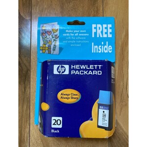 May include: A blue and yellow box with the HP logo and the text "Hewlett Packard" on it. The box contains a black ink cartridge labeled "20" and "Black". The box also has the text "Always Clear, Always Sharp" on it.