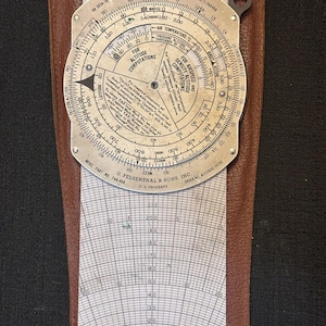 May include: A vintage, circular, metal Dead Reckoning Computer with a brown leather case. The computer has a dial with markings for altitude, airspeed, and density altitude. The case has a chart for correcting airspeed for altitude.
