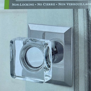 May include: A clear glass door knob with a silver trim. The knob is labeled "Hall and Closet" and "Non-Locking, No Cierre, Non Verrouillage".