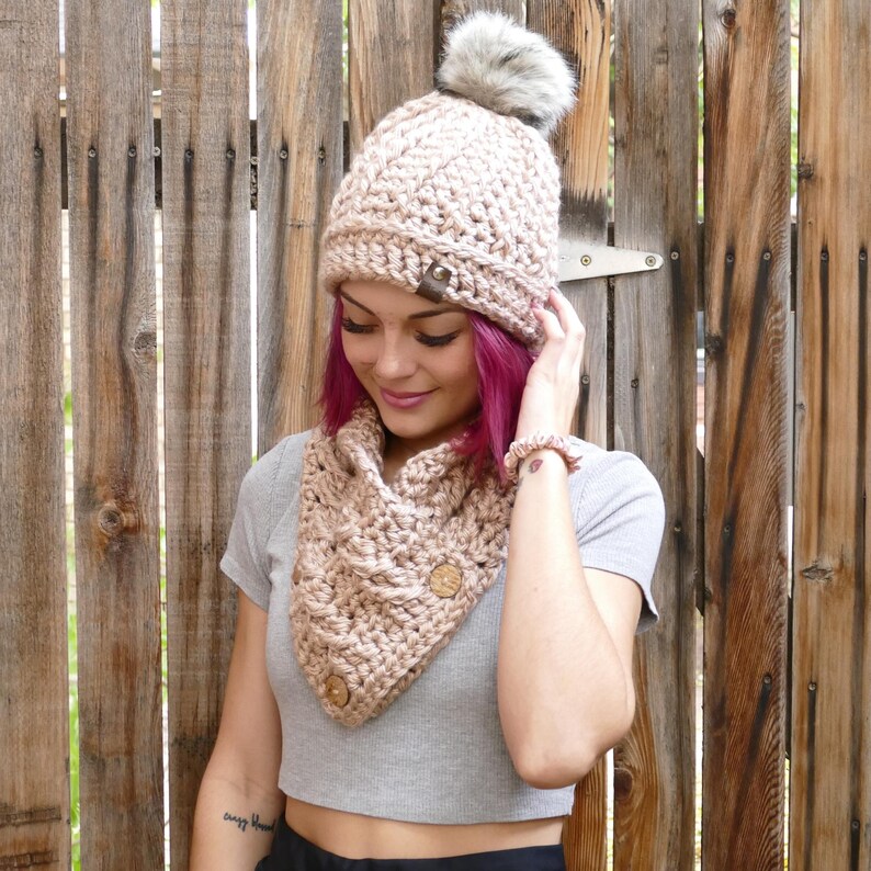 Elegant crochet cable button scarf made with super bulky yarn for warmth and rich texture. Features classic cable stitches and decorative buttons for a cozy, stylish finish. Shown in soft neutral tones, perfect for layering during fall and winter. Quick and easy PDF crochet pattern for beginners and advanced makers. A beautiful handmade cowl or neck warmer ideal for gifts, markets, or personal winter wear.