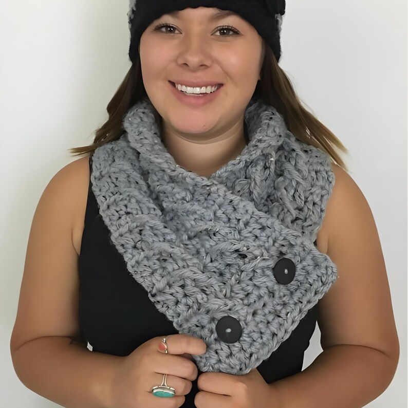 Elegant crochet cable button scarf made with super bulky yarn for warmth and rich texture. Features classic cable stitches and decorative buttons for a cozy, stylish finish. Shown in soft neutral tones, perfect for layering during fall and winter. Quick and easy PDF crochet pattern for beginners and advanced makers. A beautiful handmade cowl or neck warmer ideal for gifts, markets, or personal winter wear.