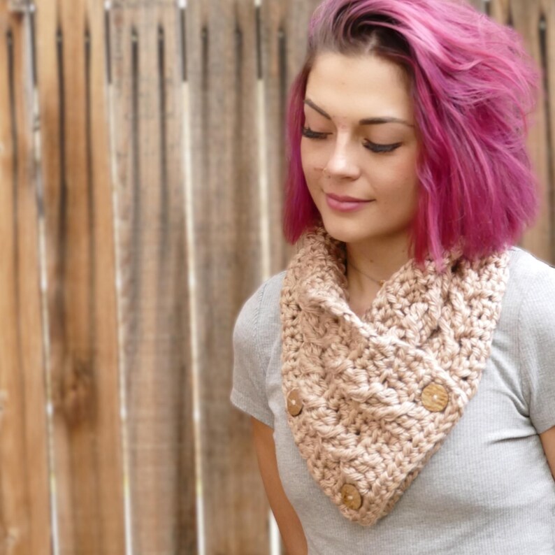 Elegant crochet cable button scarf made with super bulky yarn for warmth and rich texture. Features classic cable stitches and decorative buttons for a cozy, stylish finish. Shown in soft neutral tones, perfect for layering during fall and winter. Quick and easy PDF crochet pattern for beginners and advanced makers. A beautiful handmade cowl or neck warmer ideal for gifts, markets, or personal winter wear.
